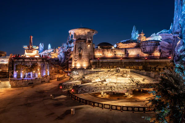 The Star Wars Millennium Falcon: Smugglers Run ride in the Galaxy's Edge land of Disneyland Resort and Walt Disney World Resort, featuring the Millennium Falcon docked at Black Spire Outpost on Batuu.